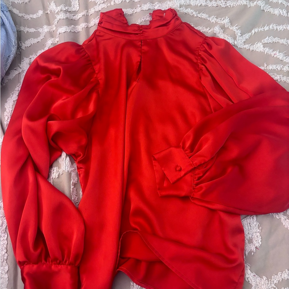 Red silk blouse with a cut and dramatic sleeves. worn once